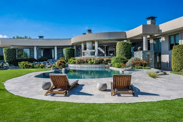 a table and chairs in front of house and outdoor seating