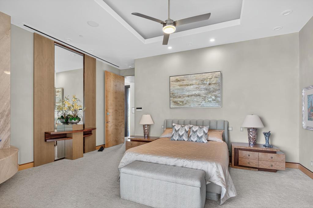 17534 Los Morros Rancho Santa Fe, CA 92067 - Photo 11 of 40 a bedroom with a large bed and a chandelier