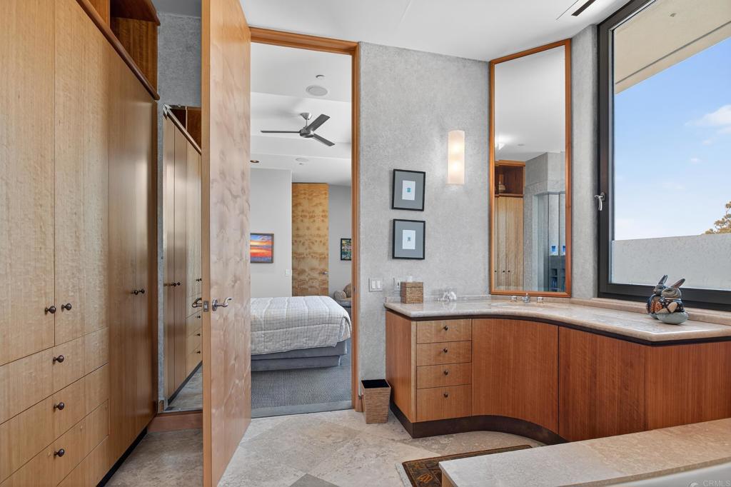 17534 Los Morros Rancho Santa Fe, CA 92067 - Photo 19 of 40 a bathroom with a sink a mirror and a shower