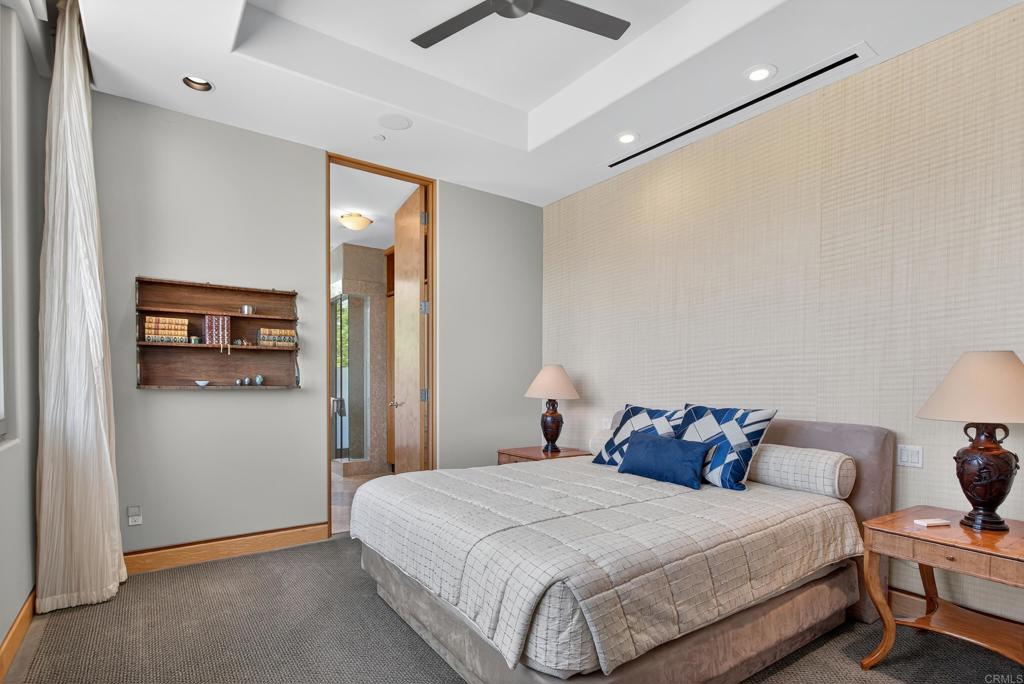 17534 Los Morros Rancho Santa Fe, CA 92067 - Photo 22 of 40 a bedroom with a bed and a lamp on the dresser