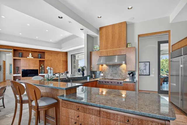 a kitchen with granite countertop a table and chairs