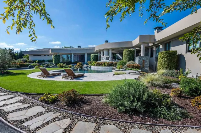 a front view of a house with garden