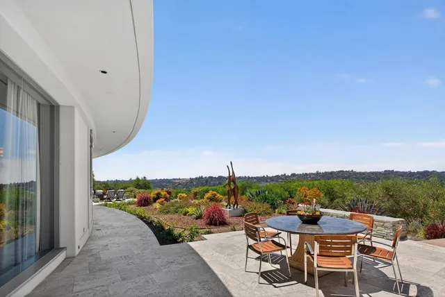 a view of a chairs and table in patio
