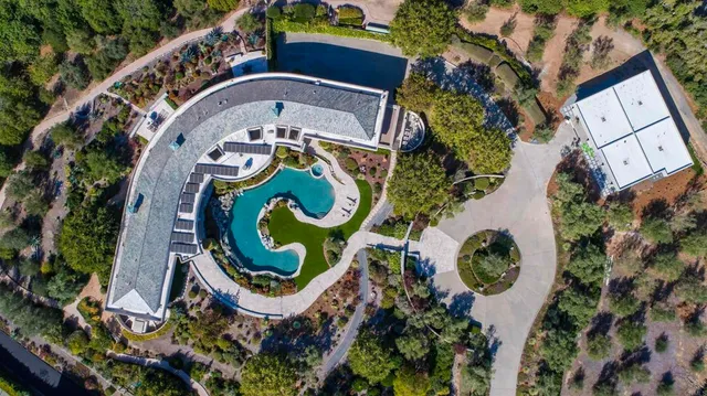 aerial view of a house with a swimming pool and outdoor seating