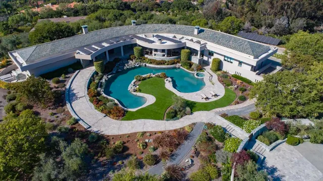 an aerial view of a house with outdoor space pool seating area and yard
