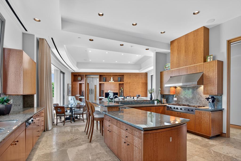17534 Los Morros Rancho Santa Fe, CA 92067 - Photo 8 of 40 a kitchen with stainless steel appliances granite countertop a sink and a refrigerator