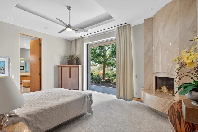 a bedroom with furniture a fireplace and a window