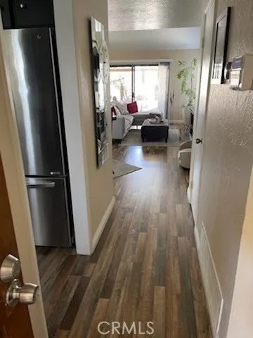 a view of a living room with wooden floor and a window
