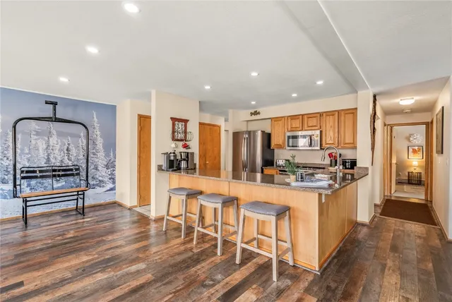a kitchen with stainless steel appliances kitchen island granite countertop a stove and cabinets