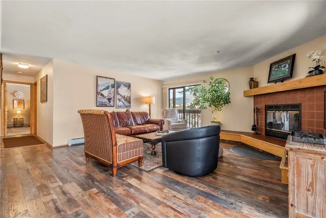 a living room with furniture a window and a fireplace