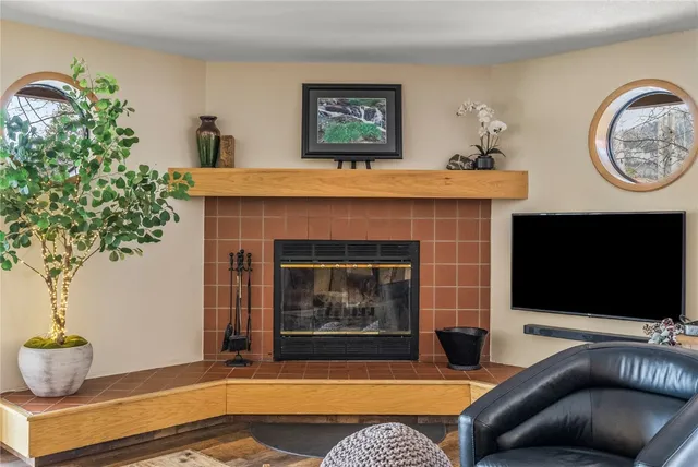 a living room with a fireplace and a flat screen tv