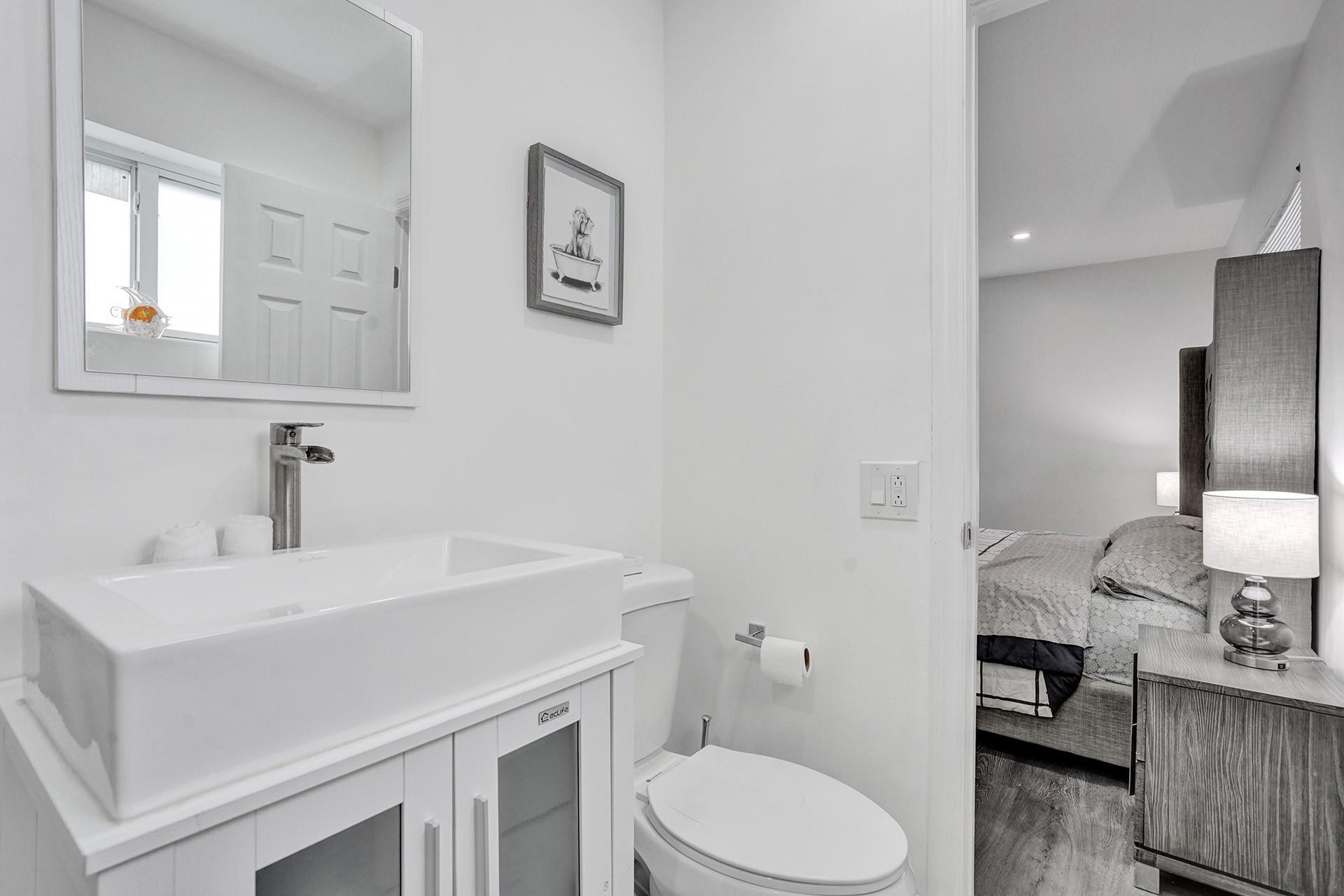 2114 North 42nd Avenue Hollywood, FL 33021 - Photo 12 of 24 a bathroom with a sink toilet and a mirror