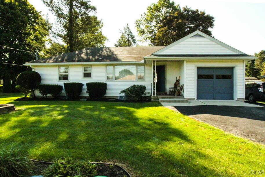 5916 Old Carriage Road Bath, PA 18014 - Photo 3 of 28 a front view of a house with a yard and trees