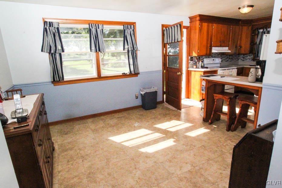 5916 Old Carriage Road Bath, PA 18014 - Photo 7 of 28 a kitchen with stainless steel appliances a refrigerator sink and cabinets