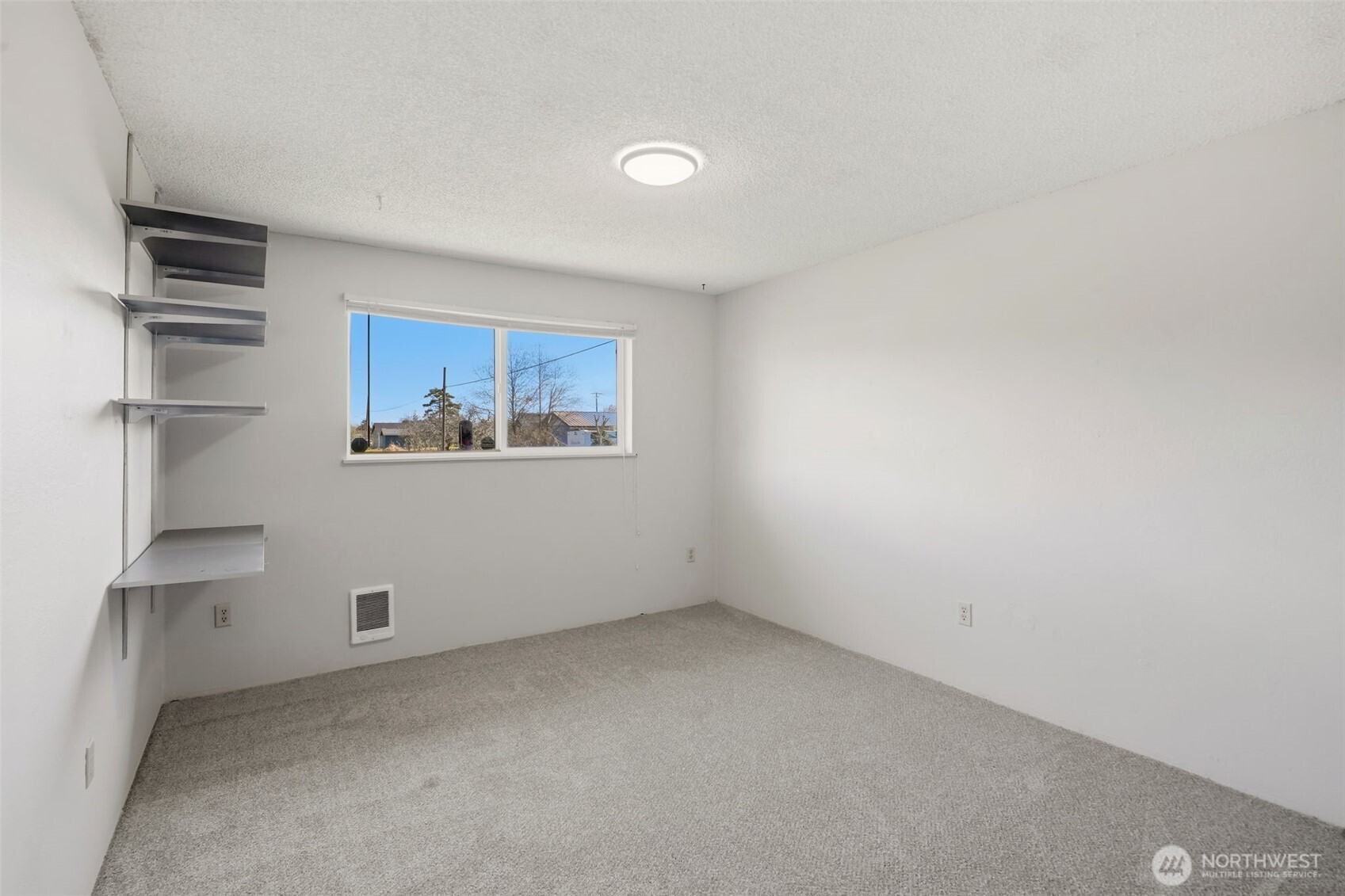 209 West Scott Street Aberdeen, WA 98520 - Photo 14 of 26 a view of an empty room with a window