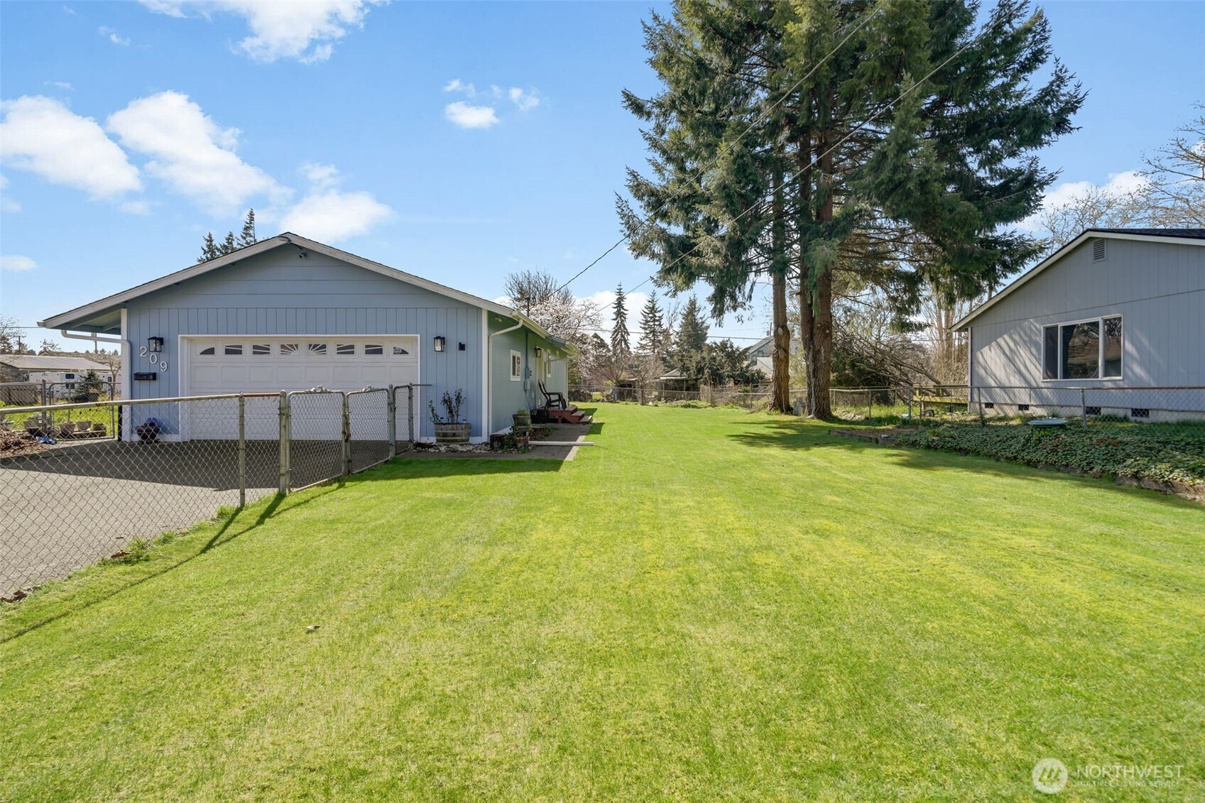 209 West Scott Street Aberdeen, WA 98520 - Photo 22 of 26 a view of a house with a big yard and large tree