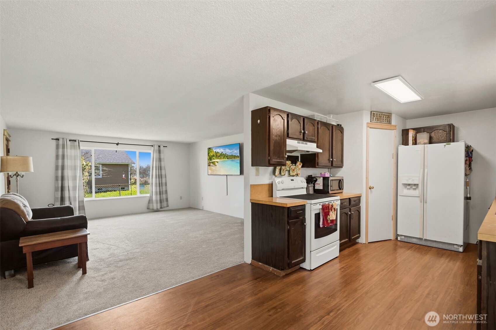 209 West Scott Street Aberdeen, WA 98520 - Photo 8 of 26 a large kitchen with cabinets and stainless steel appliances