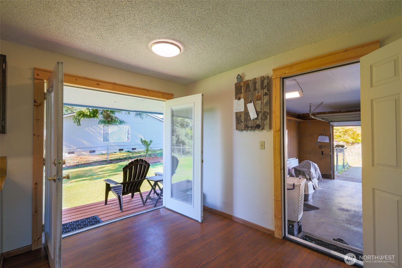 209 West Scott Street Aberdeen, WA 98520 - Photo 9 of 16 a view of a hallway with a dining room and wooden floor