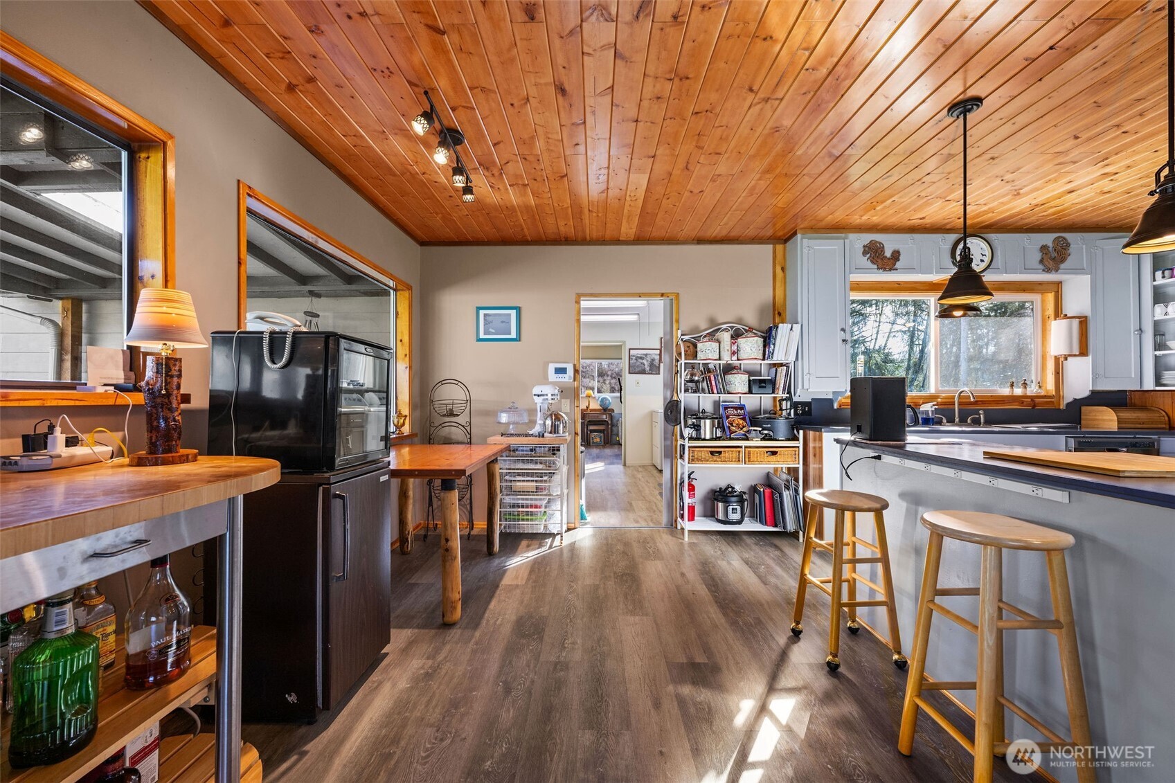 471 Barr Road Grays River, WA 98643 - Photo 11 of 40 a open kitchen with stainless steel appliances granite countertop a stove refrigerator dining table and chairs with wooden floor