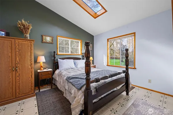 a bedroom with bed and wooden floor