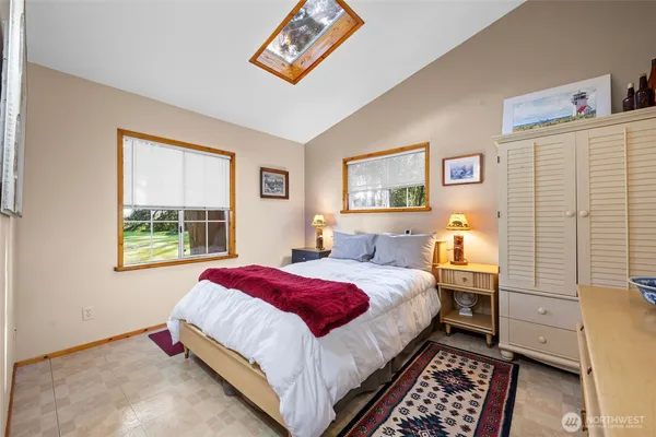 a bedroom with bed and a window