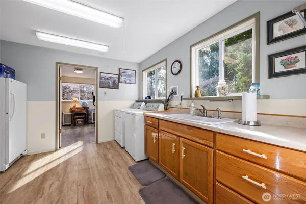 a en suite bathroom with a sink mirror and view of bedroom