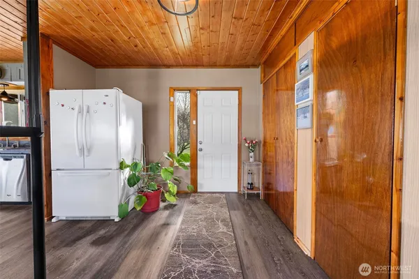a hallway with painting and wooden floor
