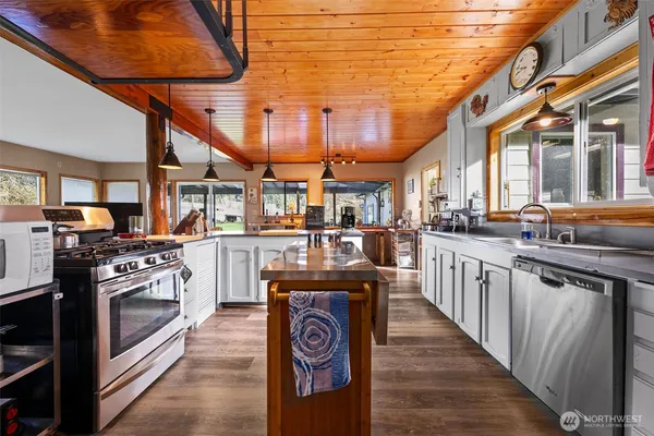 a kitchen with stainless steel appliances granite countertop a stove a sink and dishwasher