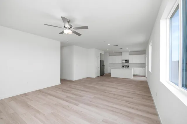 a view of a kitchen with wooden floor and a kitchen space