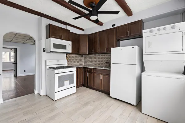 a kitchen with a refrigerator and a stove top oven