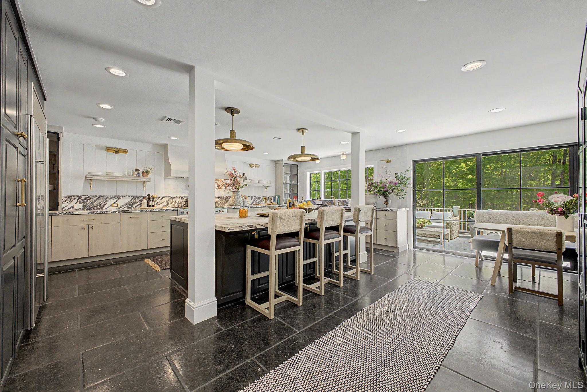 240 Eastwoods Road Pound Ridge, NY 10576 - Photo 11 of 13 a kitchen with stainless steel appliances kitchen island granite countertop a table and chairs
