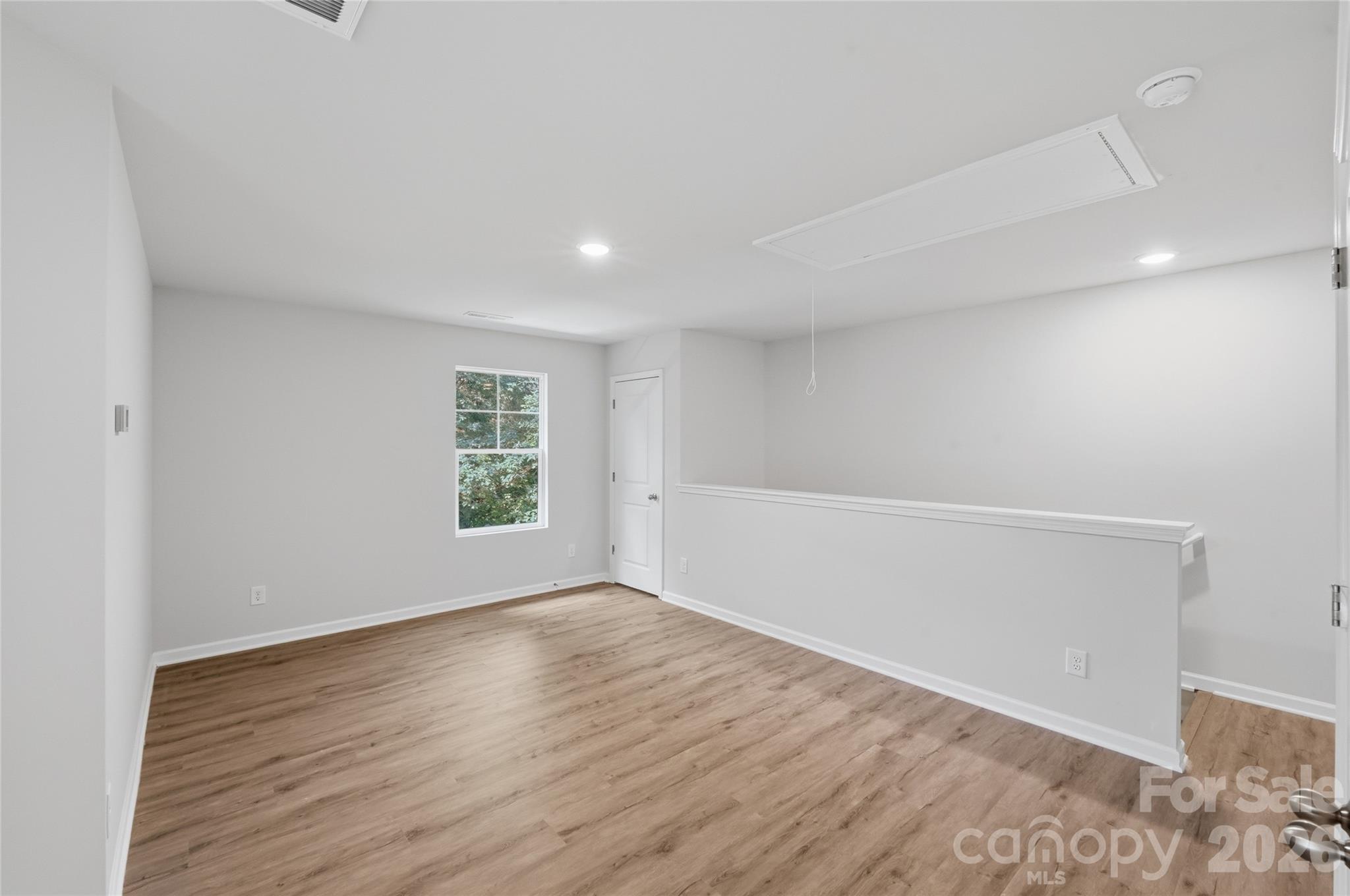 242 Landers Chapel Road Lincolnton, NC 28092 - Photo 19 of 33 a view of an empty room with wooden floor and a window