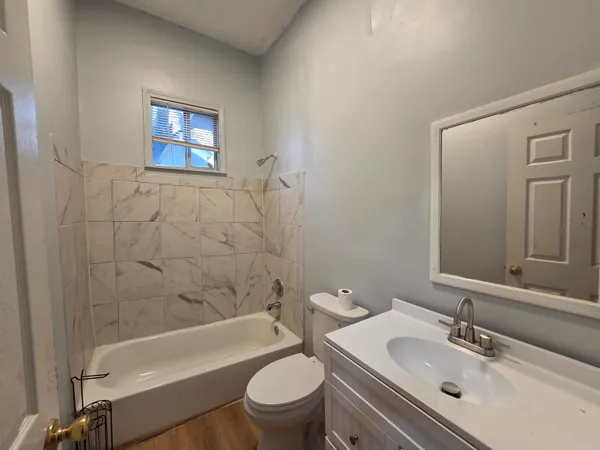 a bathroom with a sink a toilet and bathtub