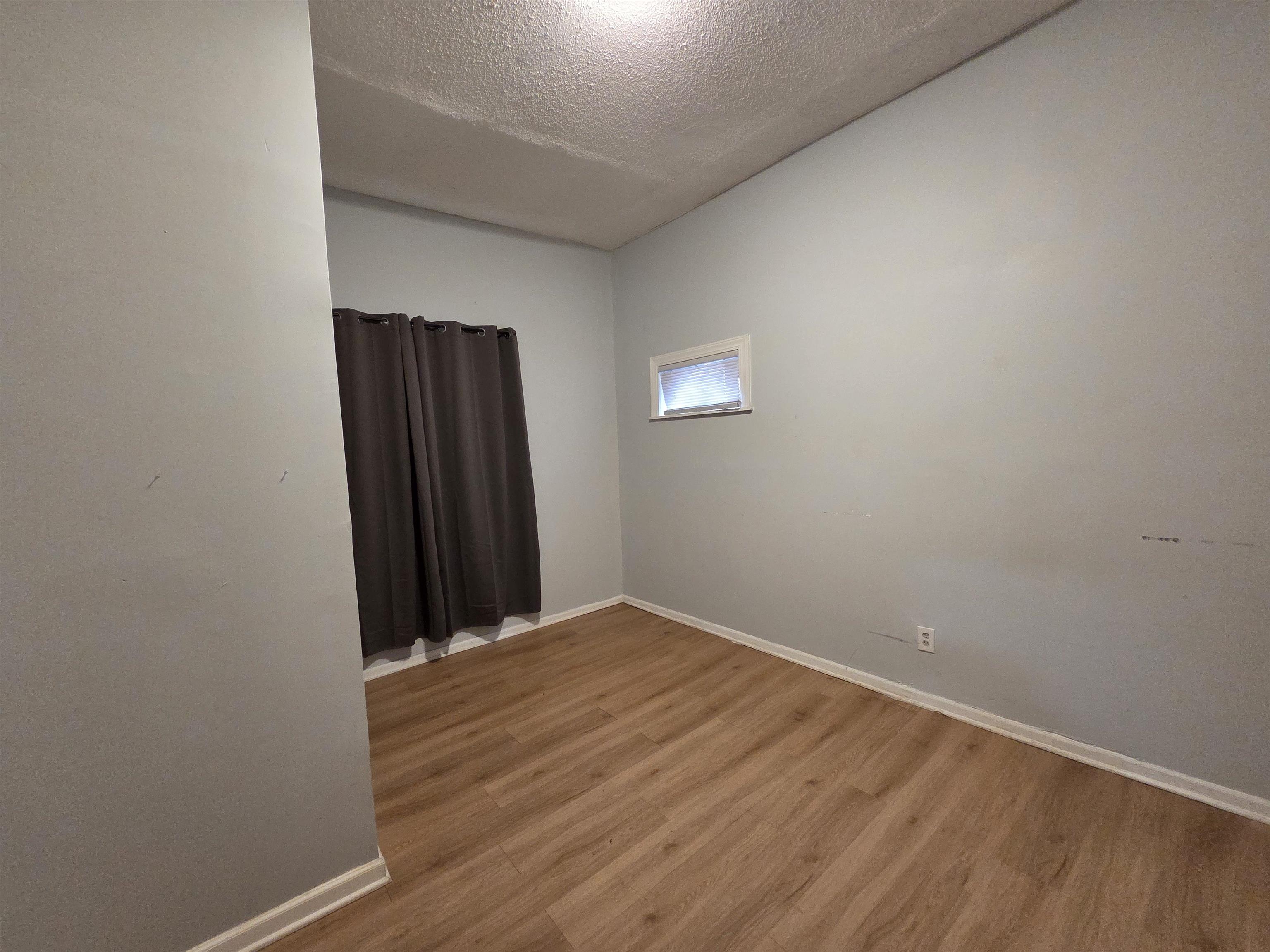993 Oakview Street, Unit 101 Memphis, TN 38114 - Photo 4 of 14 an empty room with wooden floor