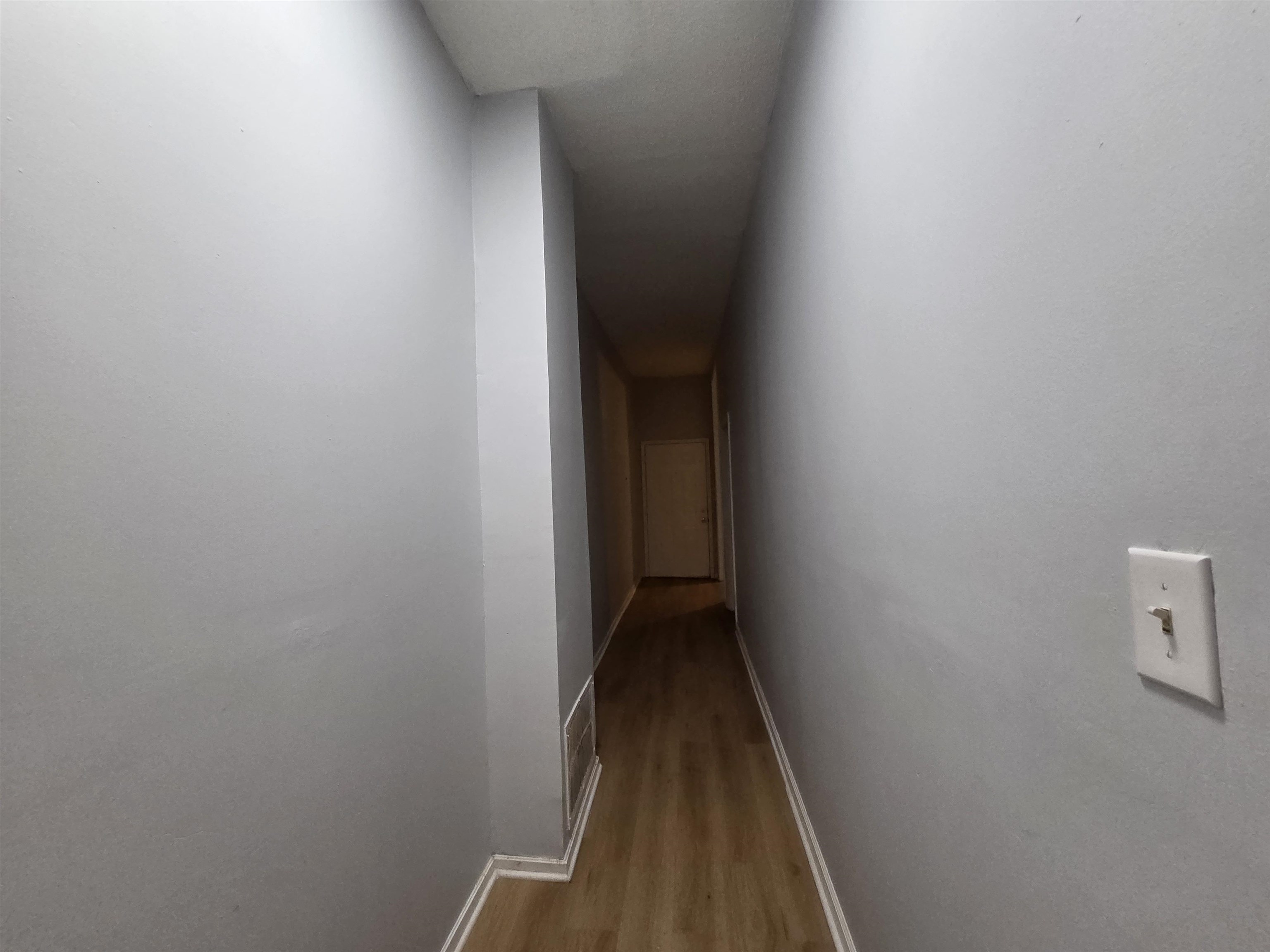 993 Oakview Street, Unit 101 Memphis, TN 38114 - Photo 5 of 14 a view of a hallway with wooden floor
