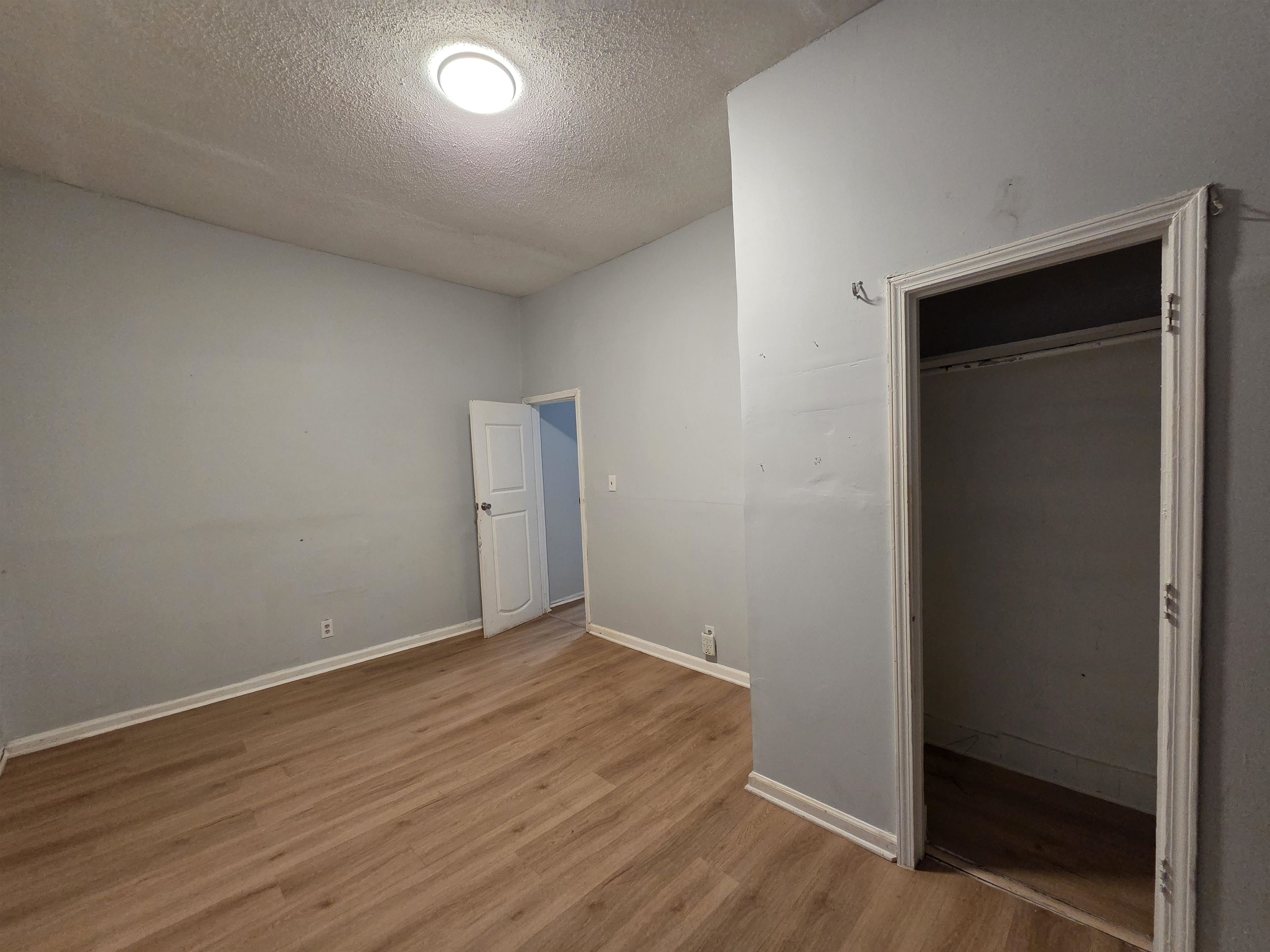 993 Oakview Street, Unit 101 Memphis, TN 38114 - Photo 6 of 14 an empty room with wooden floor and closet
