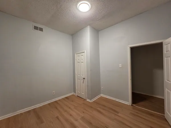 an empty room with wooden floor