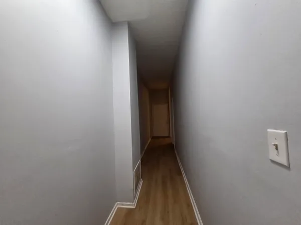 an empty room with wooden floor and closet