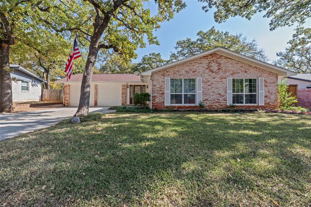 Ranch-style house featuring brick siding, driveway