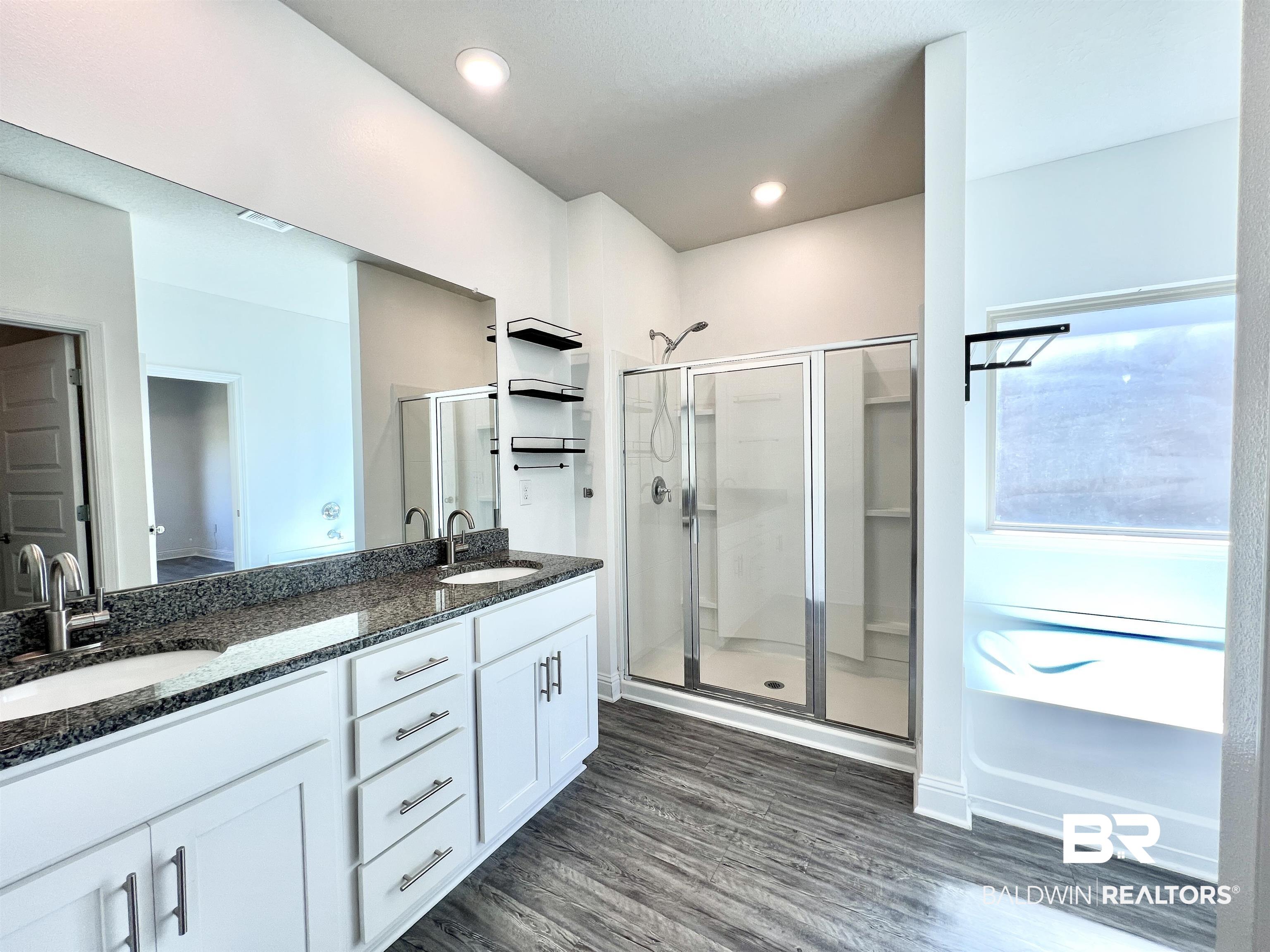 24785 Slater Mill Road Daphne, AL 36526 - Photo 31 of 46 Bathroom featuring vanity, wood-type flooring, and a shower with door