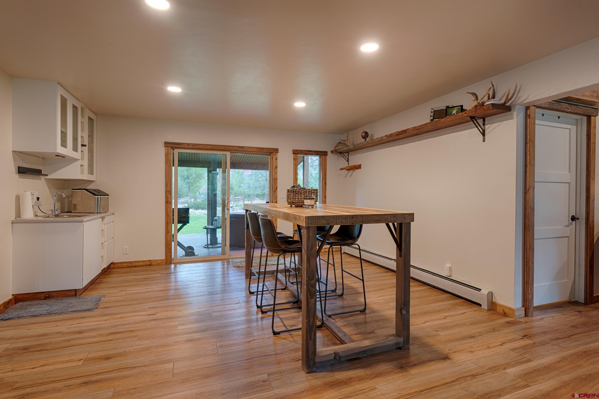 559 Suzanne Lane Ridgway, CO 81432 - Photo 10 of 45 a view of a dining room with furniture and wooden floor