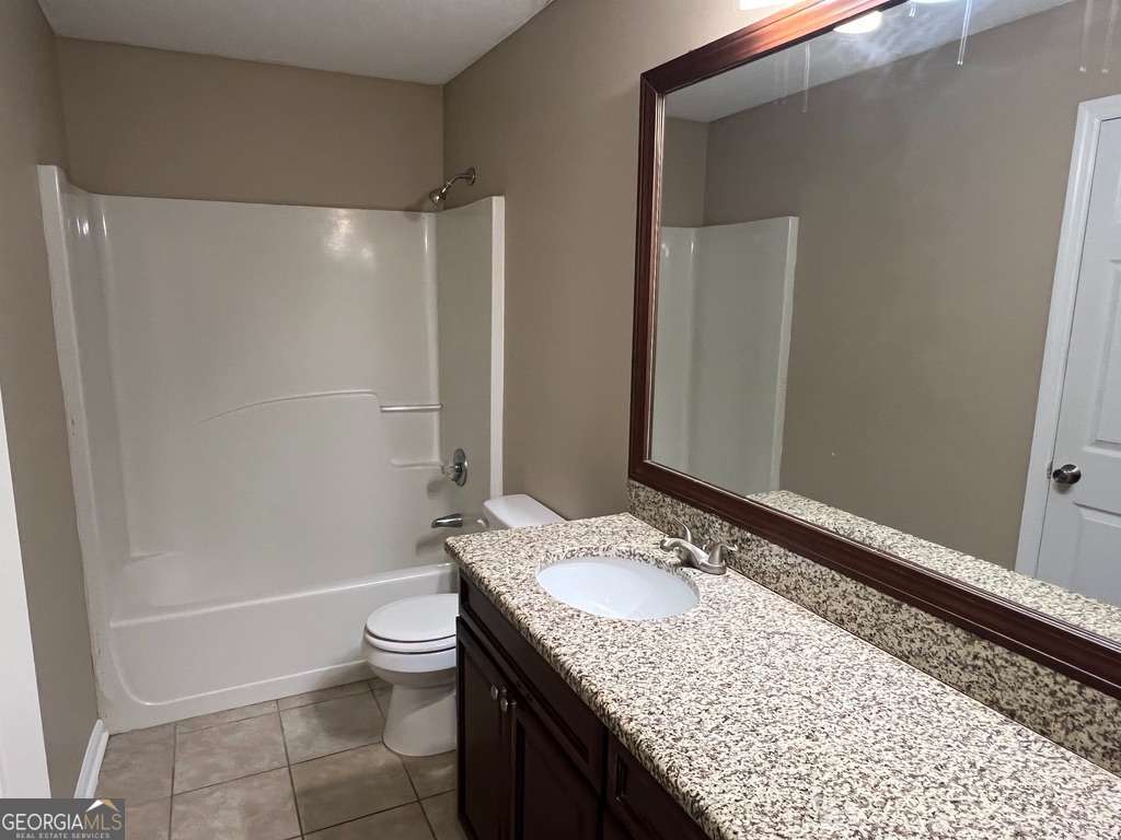 202 Thompson Court St. Marys, GA 31558 - Photo 12 of 15 a bathroom with a granite countertop sink toilet and shower