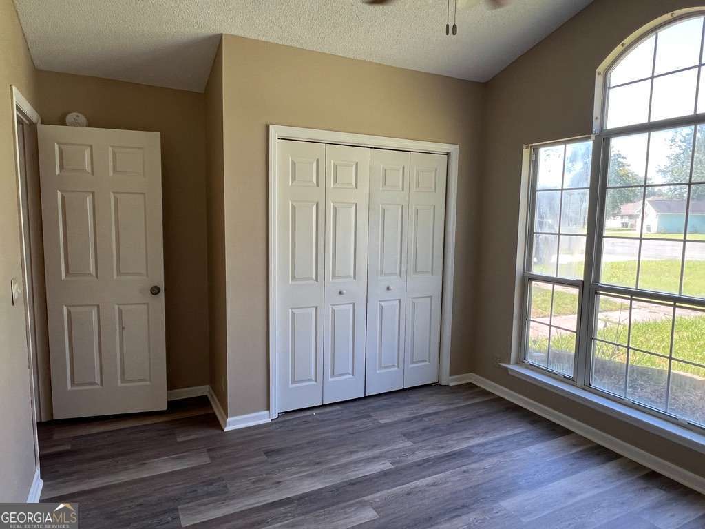 202 Thompson Court St. Marys, GA 31558 - Photo 15 of 15 an empty room with wooden floor and windows