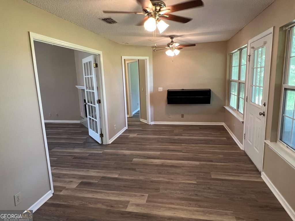 202 Thompson Court St. Marys, GA 31558 - Photo 6 of 15 wooden floor in an empty room with a window