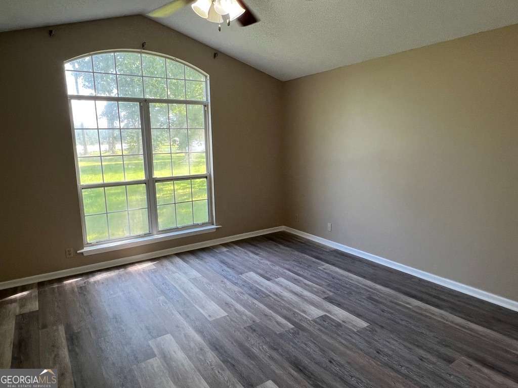 202 Thompson Court St. Marys, GA 31558 - Photo 7 of 15 an empty room with wooden floor and windows