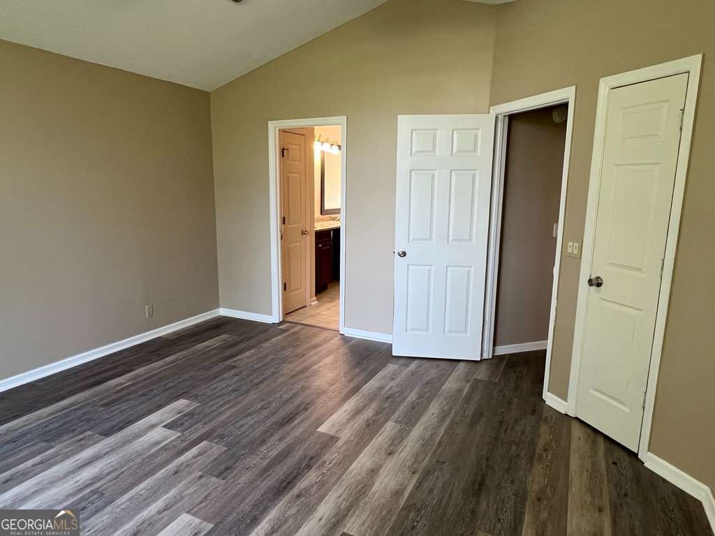 202 Thompson Court St. Marys, GA 31558 - Photo 8 of 15 a view of an empty room with wooden floor and closet