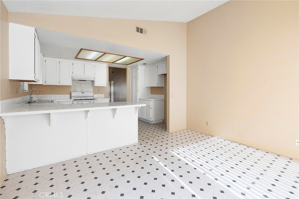 3665 Anchorage Street Hemet, CA 92545 - Photo 11 of 23 a kitchen with a sink a refrigerator and cabinets