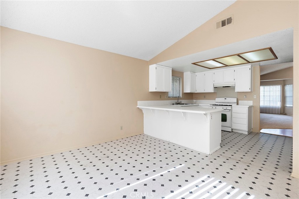 3665 Anchorage Street Hemet, CA 92545 - Photo 12 of 23 a kitchen with a sink a stove cabinets and counter space