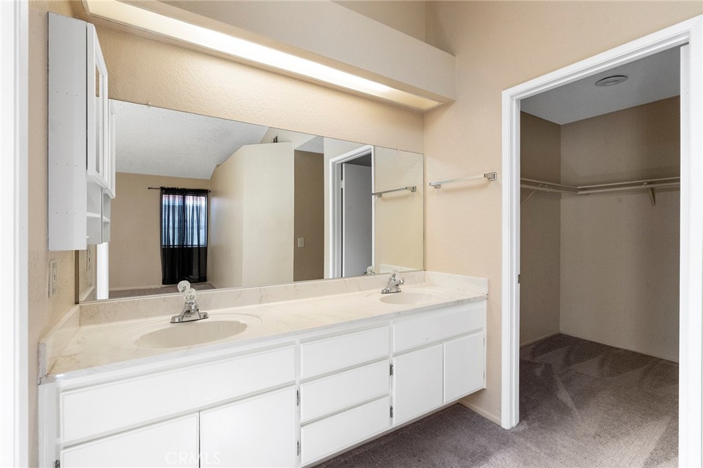 3665 Anchorage Street Hemet, CA 92545 - Photo 16 of 23 a bathroom with a double vanity sink a mirror and a shower