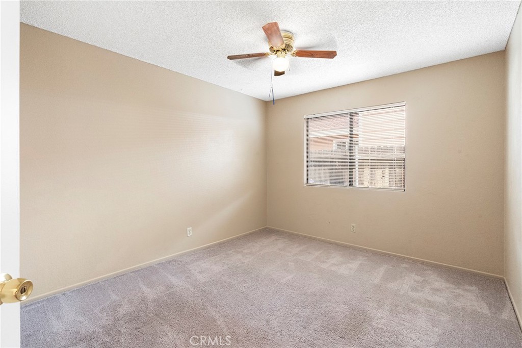 3665 Anchorage Street Hemet, CA 92545 - Photo 18 of 23 an empty room with windows and fan